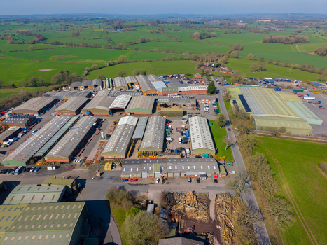 Aerial view of Ladfordfields Industrial Estate with multiple warehouse buildings storage yards and surrounding green fields in Stafford England United Kingdom. Aerial view of Ladfordfields Industrial Estate with multiple warehouse buildings storage yards and surrounding green fields in Stafford England United Kingdom.