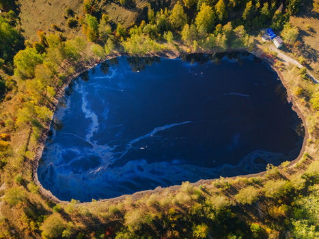 Aerial view of the Gudronove jamy acid tar lagoons surrounded by dense autumn forest and colorful trees in Predajna Banskobystricky kraj Slovakia. Aerial view of the Gudronove jamy acid tar lagoons surrounded by dense autumn forest and colorful trees in Predajna Banskobystricky kraj Slovakia.