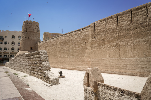 View of the historic Al Fahidi Fort with its traditional stone walls and watchtower under a clear blue sky in Dubai Dubai United Arab Emirates. View of the historic Al Fahidi Fort with its traditional stone walls and watchtower under a clear blue sky in Dubai Dubai United Arab Emirates.