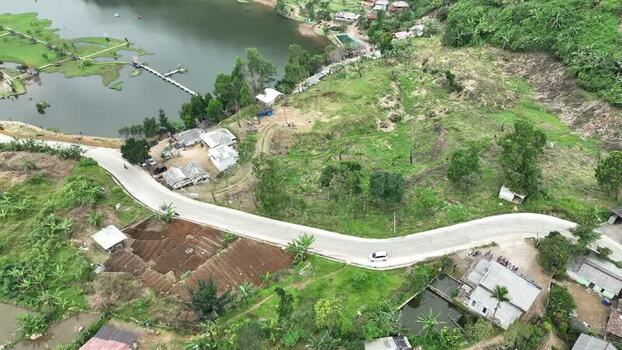 Aerial view of Rawa Gede Jonggol Lake and a winding road Indonesia.