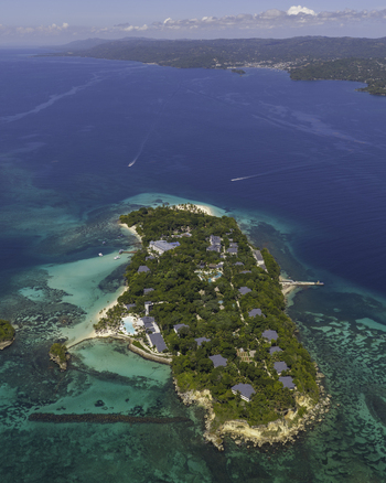 Aerial view of Cayo Levantado Beach surrounded by lush tropical vegetation turquoise waters and coral reefs in Samana SAMANA Dominican Republic. Aerial view of Cayo Levantado Beach surrounded by lush tropical vegetation turquoise waters and coral reefs in Samana SAMANA Dominican Republic.