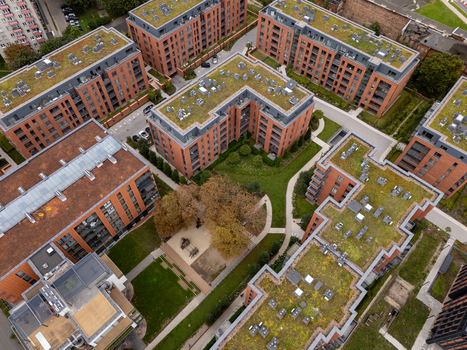 Aerial view of a modern residential complex with red brick buildings green roofs and landscaped courtyards in Gdansk Poland. Aerial view of a modern residential complex with red brick buildings green roofs and landscaped courtyards in Gdansk Poland.