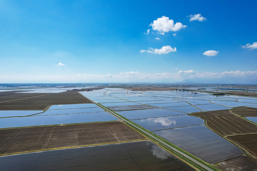 Aerial view of flooded rice fields reflecting the blue sky and clouds at Azienda Agricola Veneria in Veneria Piemonte Italy. Aerial view of flooded rice fields reflecting the blue sky and clouds at Azienda Agricola Veneria in Veneria Piemonte Italy.