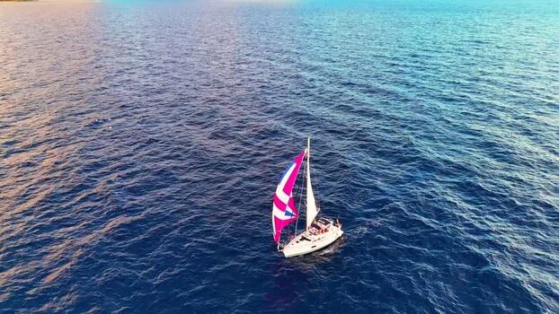 Aerial view of a sailboat on the blue ocean United States. Aerial view of a sailboat on the blue ocean United States.