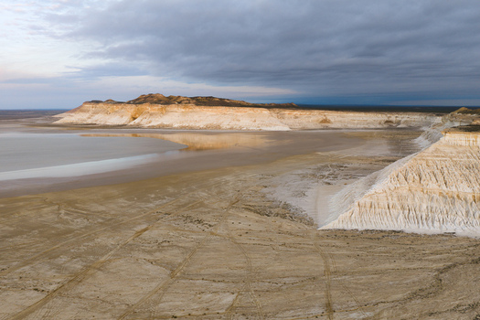 Aerial view of the dramatic white chalk cliffs and salt flats of Tuzbair under a cloudy sky in Mangystau District Mangystau Region Kazakhstan.