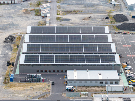 Aerial view of the Tesla Gigafactory Berlin Brandenburg featuring extensive rooftop solar panels on a large industrial facility in Grunheide Brandenburg Germany. Aerial view of the Tesla Gigafactory Berlin Brandenburg featuring extensive rooftop solar panels on a large industrial facility in Grunheide Brandenburg Germany.