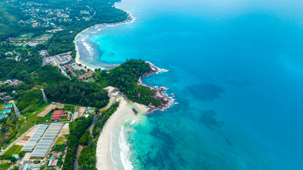 Aerial view of Grand Anse Mahe coastline featuring turquoise waters sandy beaches and lush tropical vegetation in Grand Anse Mahe Seychelles. Aerial view of Grand Anse Mahe coastline featuring turquoise waters sandy beaches and lush tropical vegetation in Grand Anse Mahe Seychelles.