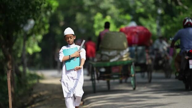 View of a young boy walking on a road in Bogura Bangladesh.
