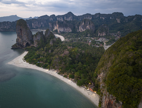 Aerial view of majestic limestone cliffs meet the turquoise sea fringed by a white sandy beach Railay Beach Krabi Thailand. Aerial view of majestic limestone cliffs meet the turquoise sea fringed by a white sandy beach Railay Beach Krabi Thailand.