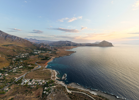Aerial view of Riserva Naturale Orientata dello Zingaro with rugged cliffs Mediterranean coastline and calm sea at sunset in San Vito Lo Capo Sicilia Italy. Aerial view of Riserva Naturale Orientata dello Zingaro with rugged cliffs Mediterranean coastline and calm sea at sunset in San Vito Lo Capo Sicilia Italy.