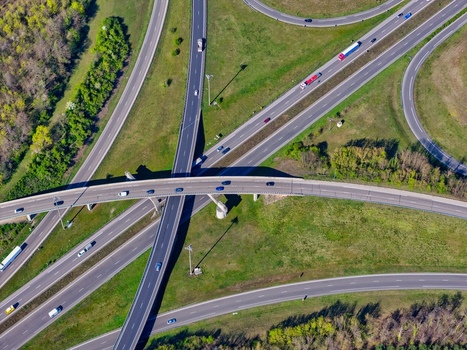 Aerial view of a complex highway interchange system with green spaces and sparse traffic flow Sausheim Grand Est France.