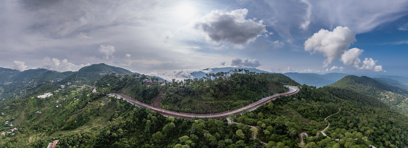 Aerial view of the Islamabad Murree Expressway winding through the lush green mountainous landscape of Lower Topa Punjab Pakistan. Aerial view of the Islamabad Murree Expressway winding through the lush green mountainous landscape of Lower Topa Punjab Pakistan.