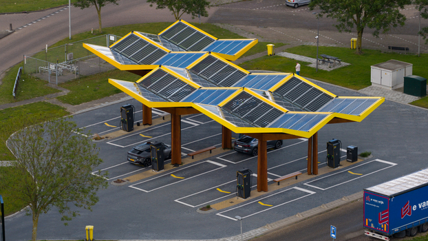 Oostzaan Netherlands 09 June 2026 Aerial view of the Fastned Charging Station featuring a distinctive yellow solar panel roof with electric vehicles parked at charging points.