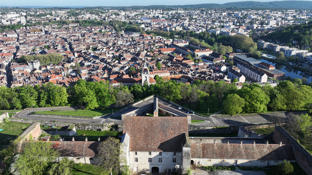 Aerial view of the Besancon Citadel overlooking the historic old town with its red tiled rooftops and lush greenery in Besancon Bourgogne Franche Comte France. Aerial view of the Besancon Citadel overlooking the historic old town with its red tiled rooftops and lush greenery in Besancon Bourgogne Franche Comte France.