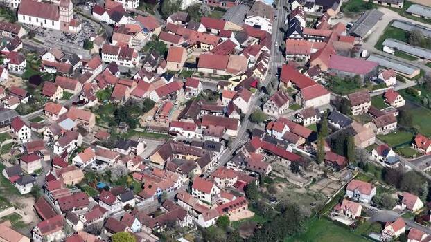 Aerial view of church and red roofed buildings France.