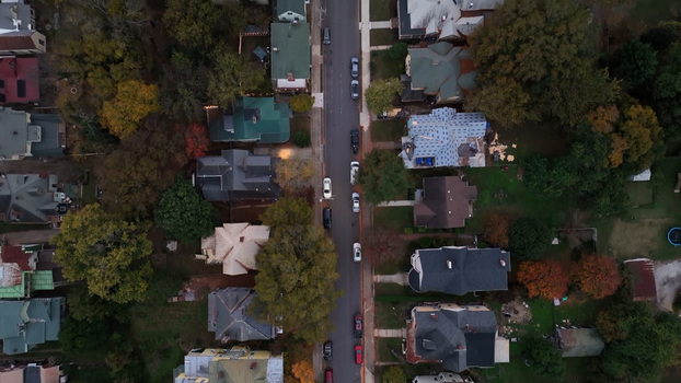Aerial view of a quiet residential street lined with historic houses and autumn trees in Danville Virginia United States.