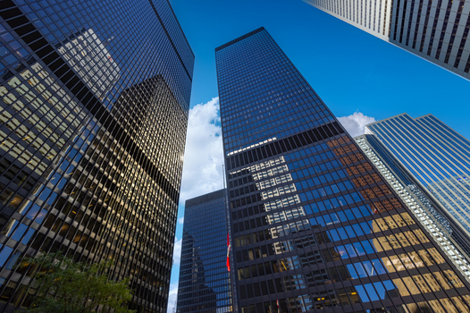 View of modern glass skyscrapers and office towers reflecting the blue sky in the financial district of Toronto Ontario Canada. View of modern glass skyscrapers and office towers reflecting the blue sky in the financial district of Toronto Ontario Canada.