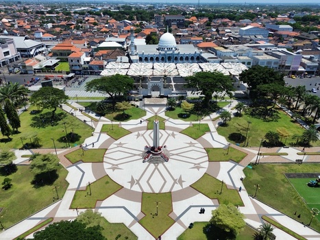 Aerial view of Alun Alun Pasuruan with a central monument geometric plaza green lawns and Al Anwar Great Mosque in Kecamatan Panggungrejo Jawa Timur Indonesia. Aerial view of Alun Alun Pasuruan with a central monument geometric plaza green lawns and Al Anwar Great Mosque in Kecamatan Panggungrejo Jawa Timur Indonesia.