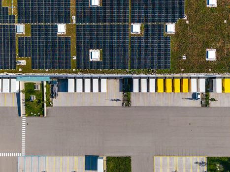 Aerial view of Logistikzentrum Allhaming featuring a large green roof with solar panels and loading docks in Allhaming Oberosterreich Austria. Aerial view of Logistikzentrum Allhaming featuring a large green roof with solar panels and loading docks in Allhaming Oberosterreich Austria.
