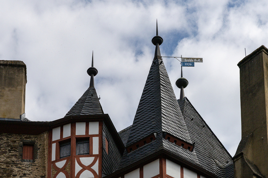 View of the medieval spires and half timbered architecture of Eltz Castle under a cloudy sky Wierschem Rhineland Palatinate Germany.