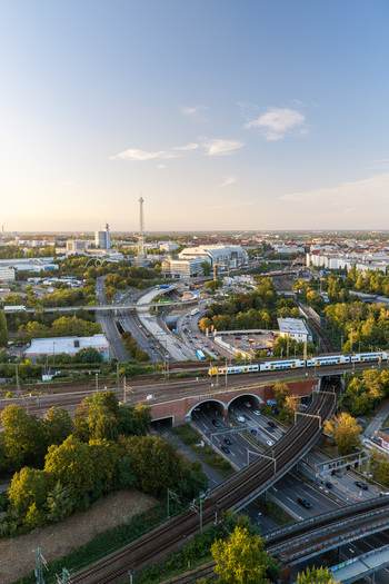 Aerial view of the ICC Berlin and surrounding urban landscape featuring Brutalist architecture railway tracks multi lane roads with traffic and green trees Berlin Berlin Germany. Aerial view of the ICC Berlin and surrounding urban landscape featuring Brutalist architecture railway tracks multi lane roads with traffic and green trees Berlin Berlin Germany.