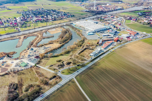 Aerial view of the town of Buttenheim featuring industrial warehouses a winding river and green agricultural fields in Buttenheim Bavaria Germany. Aerial view of the town of Buttenheim featuring industrial warehouses a winding river and green agricultural fields in Buttenheim Bavaria Germany.