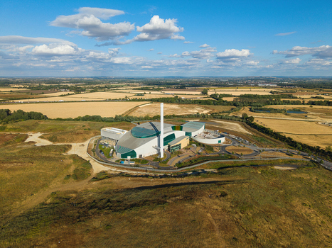 Aerial view of the Energy Recovery Facility biomass to electricity plant surrounded by agricultural fields and rural landscape in Bicester England United Kingdom.
