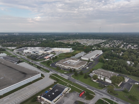 Aerial view of industrial warehouses and office buildings surrounded by parking lots and green spaces in Indianapolis Indiana United States. Aerial view of industrial warehouses and office buildings surrounded by parking lots and green spaces in Indianapolis Indiana United States.