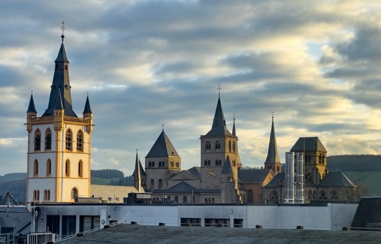 View of the historic Trier Cathedral and Church of Our Lady with their distinctive spires and towers rising above the city skyline in Trier Rheinland Pfalz Germany.