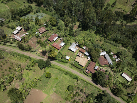 Aerial view of a small village nestled amid verdant fields and dense forests rusty rooftops contrasting with the vibrant green landscape Nyeri Nyeri Kenya. Aerial view of a small village nestled amid verdant fields and dense forests rusty rooftops contrasting with the vibrant green landscape Nyeri Nyeri Kenya.