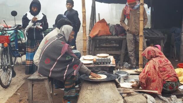 View of people at a roadside food stall in Bogura Bangladesh. View of people at a roadside food stall in Bogura Bangladesh.