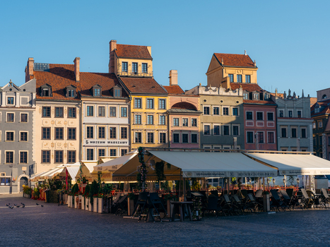 View of the historic buildings and restaurant terraces in the Warsaw Old Town square in Warsaw Masovian Voivodeship Poland. View of the historic buildings and restaurant terraces in the Warsaw Old Town square in Warsaw Masovian Voivodeship Poland.