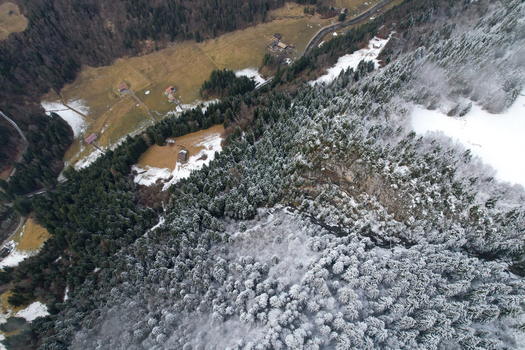 Aerial view of Les Rives area with snow covered pine forests and alpine meadows in the valley Champery Valais Switzerland.