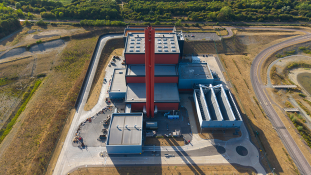 Aerial view of Rookery South ERF with its prominent tall red chimney and industrial complex surrounded by roads and landscape in Stewartby England United Kingdom. Aerial view of Rookery South ERF with its prominent tall red chimney and industrial complex surrounded by roads and landscape in Stewartby England United Kingdom.