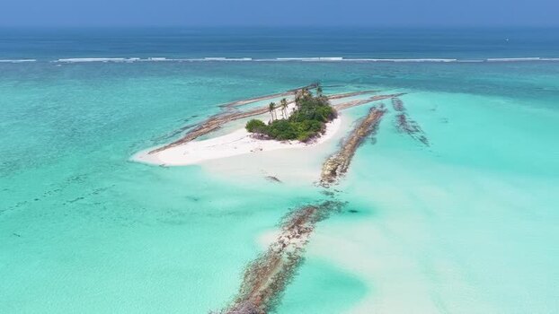 Aerial view of a tropical island in turquoise water Maldives.
