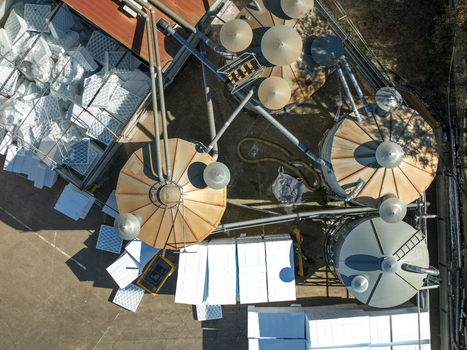 Kilsyth Australia 20 September 2026 Aerial view of an industrial facility featuring large metal silos piping systems and stacks of white polystyrene foam blocks in an outdoor storage area. Kilsyth Australia 20 September 2026 Aerial view of an industrial facility featuring large metal silos piping systems and stacks of white polystyrene foam blocks in an outdoor storage area.