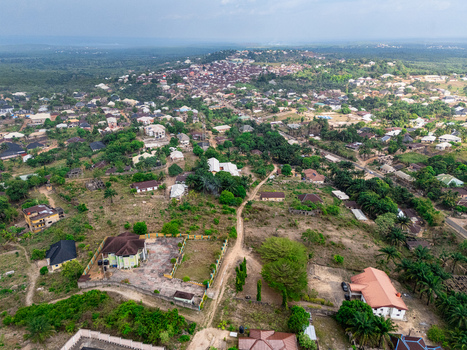Aerial view of a sprawling settlement of diverse homes nestled amidst a tapestry of verdant trees and dry earthy plots Ohafia Abia Nigeria. Aerial view of a sprawling settlement of diverse homes nestled amidst a tapestry of verdant trees and dry earthy plots Ohafia Abia Nigeria.