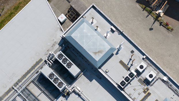 Aerial view of HVAC systems ventilation units and a central skylight on a flat industrial roof in Utrecht Utrecht Netherlands. Aerial view of HVAC systems ventilation units and a central skylight on a flat industrial roof in Utrecht Utrecht Netherlands.