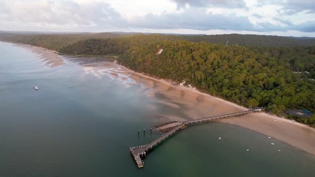Aerial view of Kingfisher Bay Resort jetty and forest Australia.