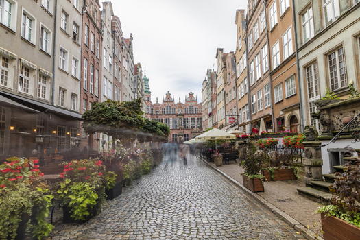 Gdansk Poland 05 September 2026 View of Mariacka Street with its historic colorful townhouses cobblestone pavement outdoor restaurant seating and lush flower pots. Gdansk Poland 05 September 2026 View of Mariacka Street with its historic colorful townhouses cobblestone pavement outdoor restaurant seating and lush flower pots.