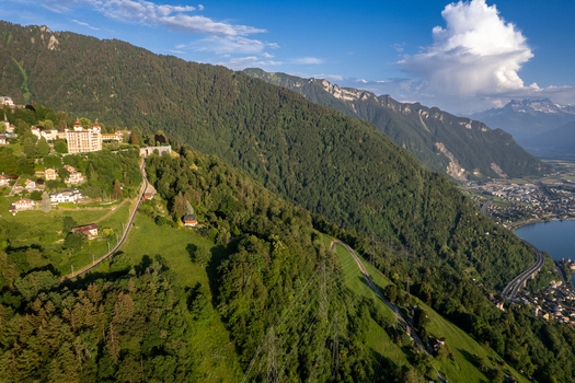 Aerial view of the historic village of Glion nestled on the steep green hillsides overlooking Lake Geneva in Montreux Vaud Switzerland. Aerial view of the historic village of Glion nestled on the steep green hillsides overlooking Lake Geneva in Montreux Vaud Switzerland.