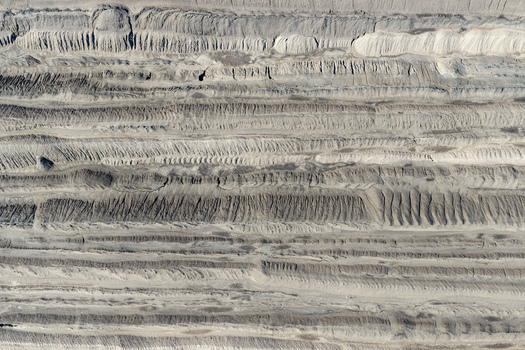 Aerial view of the textured landscape of the Tagebau Welzow Sud brown coal open pit mine showing deep excavation layers and earth patterns in Spremberg Brandenburg Germany. Aerial view of the textured landscape of the Tagebau Welzow Sud brown coal open pit mine showing deep excavation layers and earth patterns in Spremberg Brandenburg Germany.