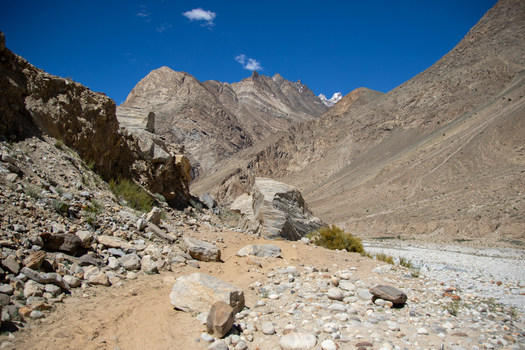 View of the rugged rocky terrain and mountain slopes near K2 Base Camp under a clear blue sky in Ghakhar Gilgit Pakistan. View of the rugged rocky terrain and mountain slopes near K2 Base Camp under a clear blue sky in Ghakhar Gilgit Pakistan.