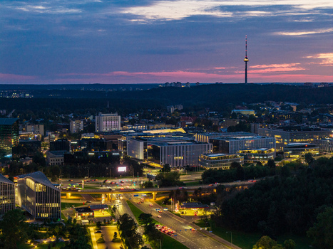 Aerial view of the Vilnius TV Tower and modern office buildings illuminated at twilight in Vilnius Vilnius County Lithuania. Aerial view of the Vilnius TV Tower and modern office buildings illuminated at twilight in Vilnius Vilnius County Lithuania.