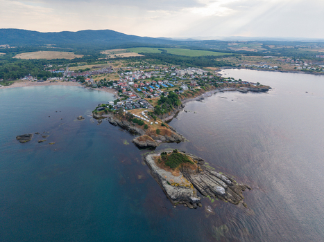 Aerial view of Arapya a coastal area with a sandy beach rocky headland and small buildings surrounded by green hills in Burgas Bulgaria. Aerial view of Arapya a coastal area with a sandy beach rocky headland and small buildings surrounded by green hills in Burgas Bulgaria.