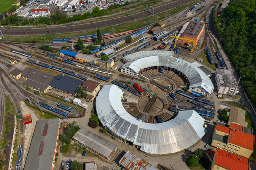 Aerial view of a circular train roundhouse depot with multiple tracks and locomotives in Prague Prague Czechia.