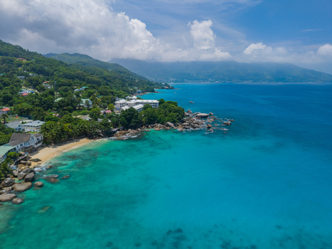 Aerial view of the turquoise waters contrasting with the lush greenery of the coastline Vista do Mar Mahe island Seychelles. Aerial view of the turquoise waters contrasting with the lush greenery of the coastline Vista do Mar Mahe island Seychelles.
