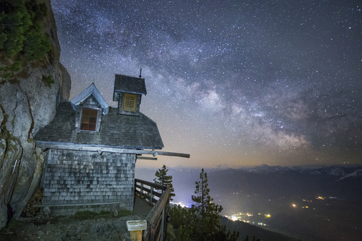 View of the historic Friedenskircherl chapel built into the rock face of Stoderzinken mountain under the Milky Way at night Liezen Steiermark Austria. View of the historic Friedenskircherl chapel built into the rock face of Stoderzinken mountain under the Milky Way at night Liezen Steiermark Austria.