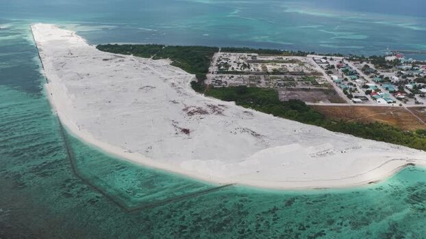 Aerial view of a tropical island and coral reefs Maldives.