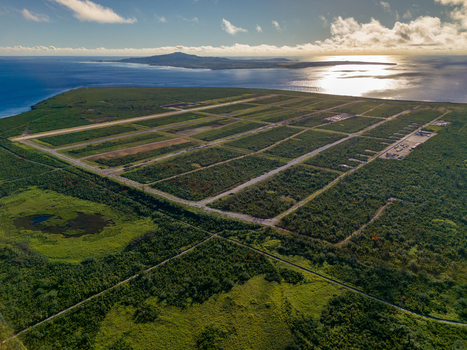 Aerial view of North Field Base with historic runways surrounded by dense tropical vegetation and the Pacific Ocean in Northern Tinian Tinian Northern Mariana Islands.